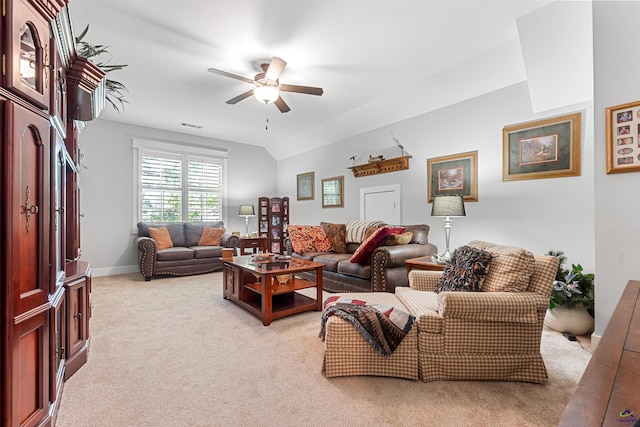 carpeted living room with ceiling fan and lofted ceiling