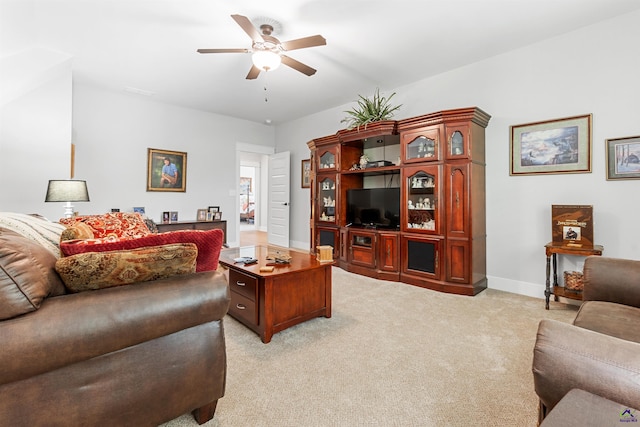 carpeted living room with ceiling fan