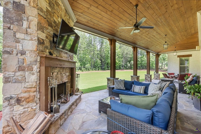 view of patio featuring an outdoor living space with a fireplace and ceiling fan