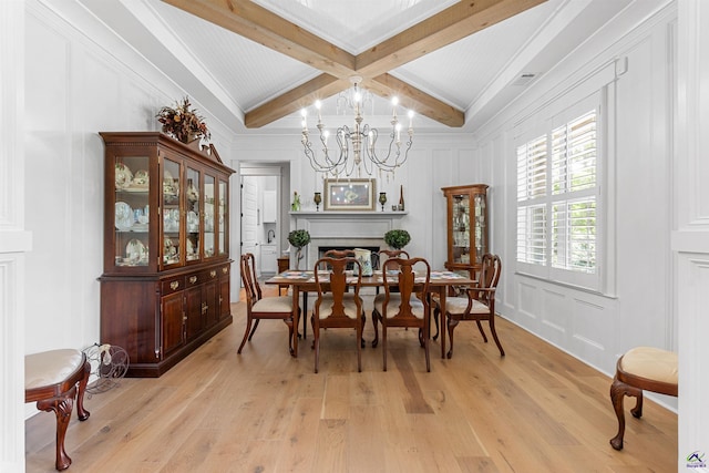 dining area featuring beamed ceiling, a notable chandelier, and light wood-type flooring