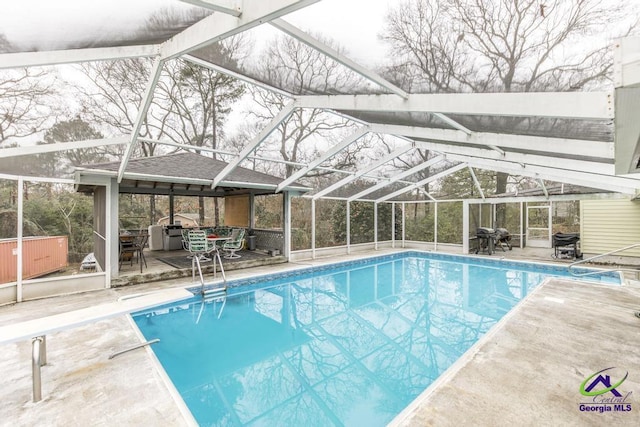 view of swimming pool with a lanai and a patio area