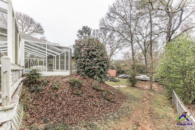 view of yard with glass enclosure