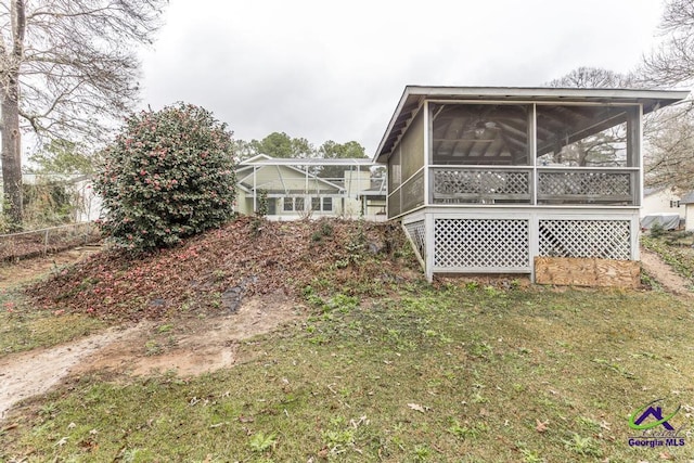 view of property exterior with a yard and a sunroom