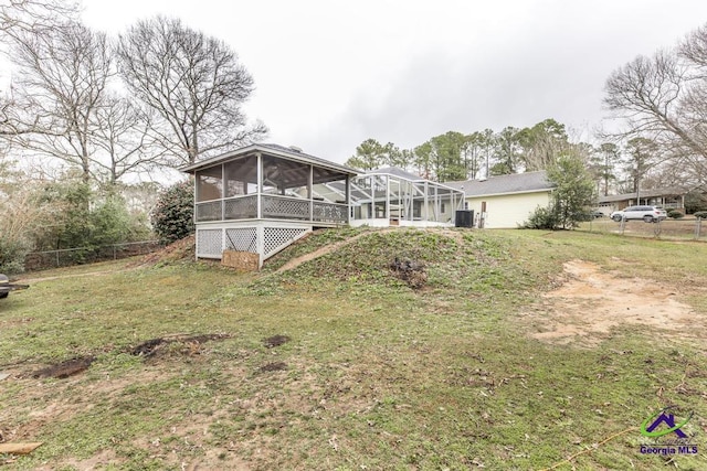 back of house with a yard and a sunroom