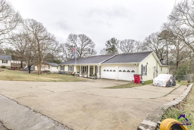 single story home with a garage, covered porch, and a front lawn