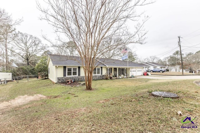 ranch-style home featuring a garage and a front yard