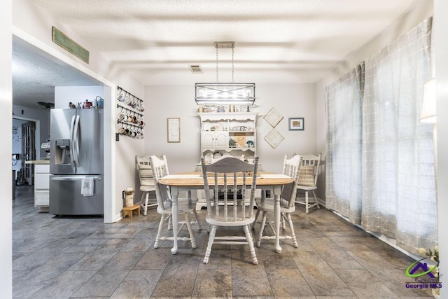 dining room with a textured ceiling