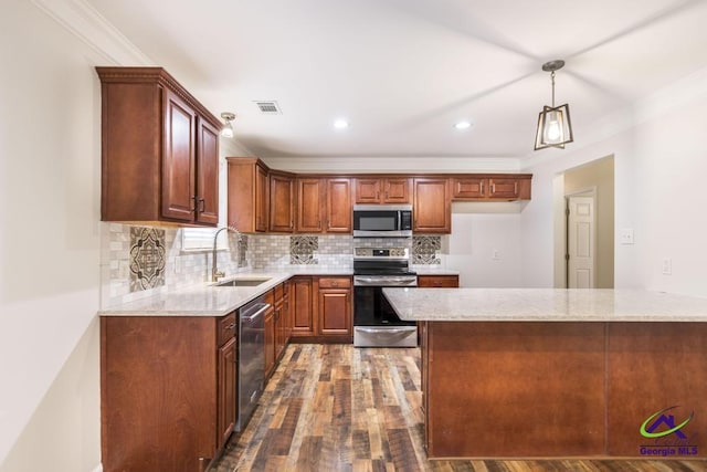 kitchen featuring pendant lighting, stainless steel appliances, light stone countertops, and sink