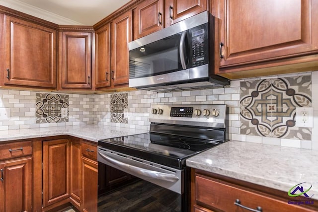 kitchen featuring light stone counters, backsplash, and stainless steel appliances