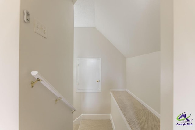 stairway featuring lofted ceiling