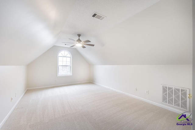 bonus room with ceiling fan, lofted ceiling, and light carpet