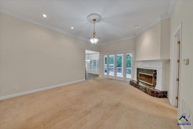 unfurnished living room with crown molding, light colored carpet, and a high end fireplace