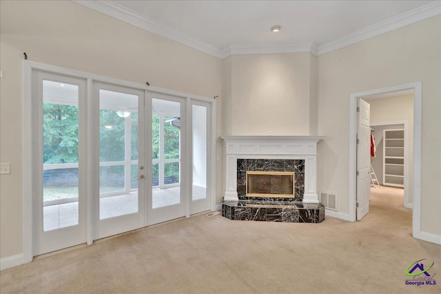 living room with french doors, ornamental molding, a fireplace, and light carpet