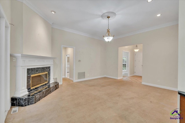 unfurnished living room with crown molding, a high end fireplace, and light carpet