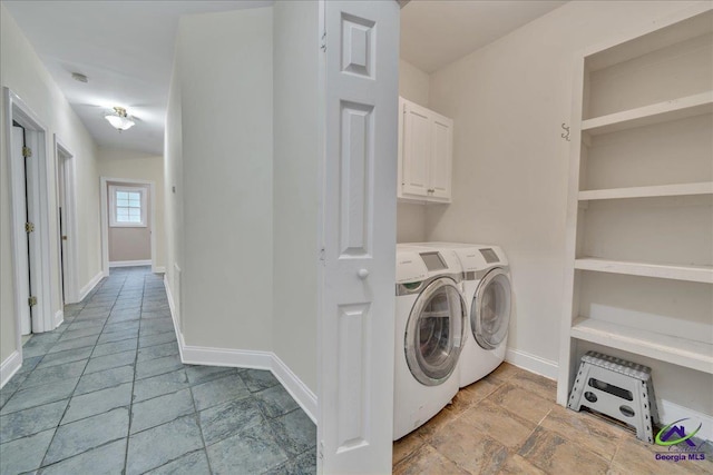 laundry area featuring separate washer and dryer and cabinets