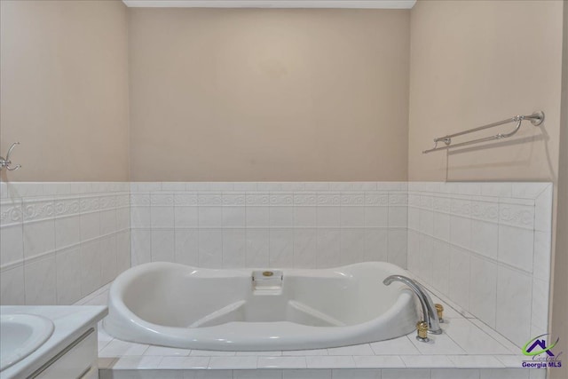 bathroom featuring vanity and a relaxing tiled tub