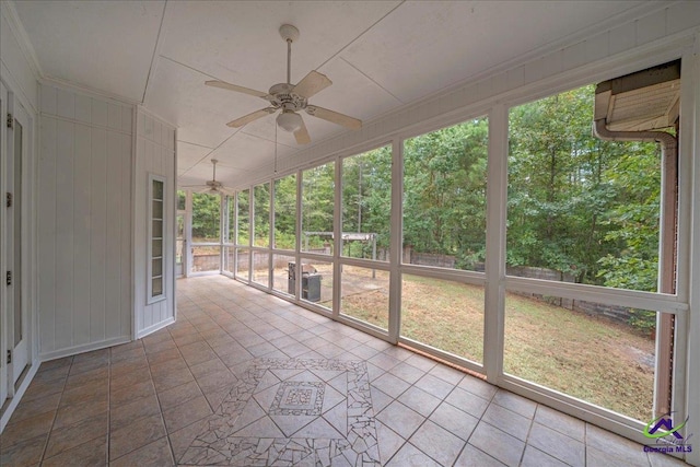 unfurnished sunroom with ceiling fan and plenty of natural light