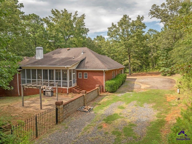 back of house featuring a sunroom