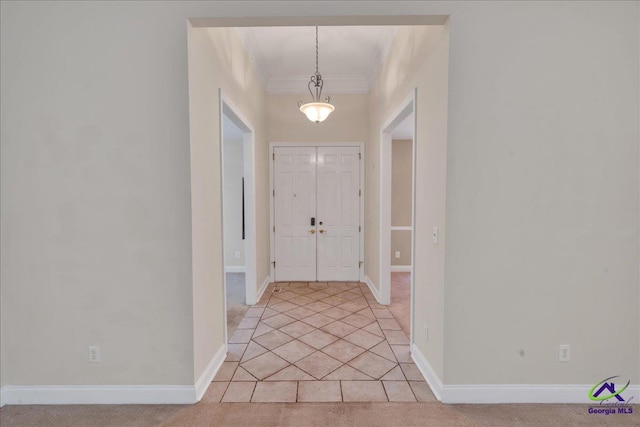 doorway to outside featuring crown molding and light tile patterned floors