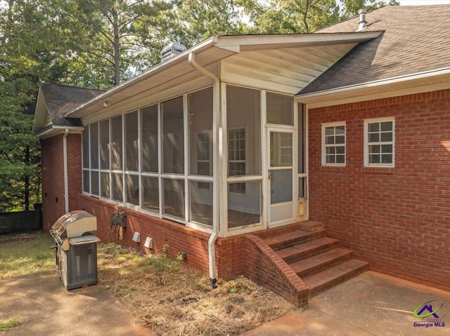 view of side of home featuring a sunroom