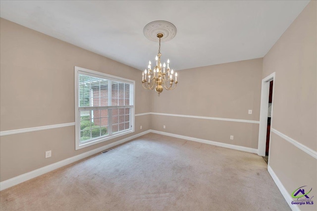 empty room with light carpet and a chandelier