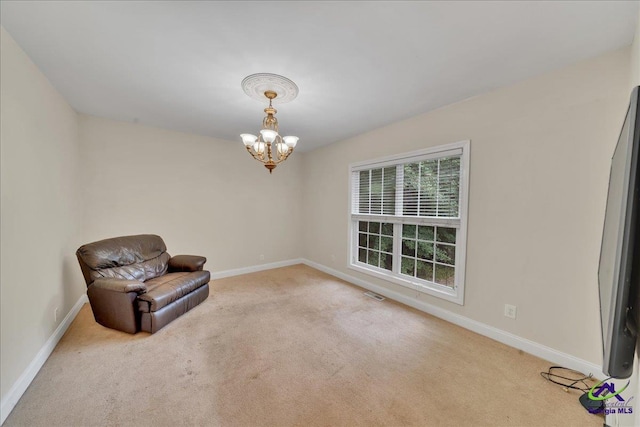 unfurnished room with light colored carpet and a notable chandelier