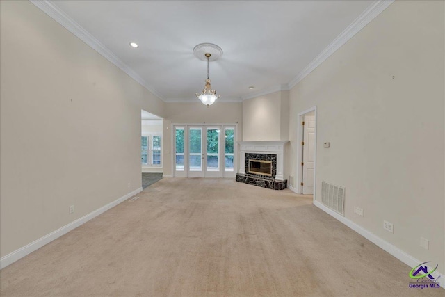 unfurnished living room featuring a premium fireplace, ornamental molding, and light carpet