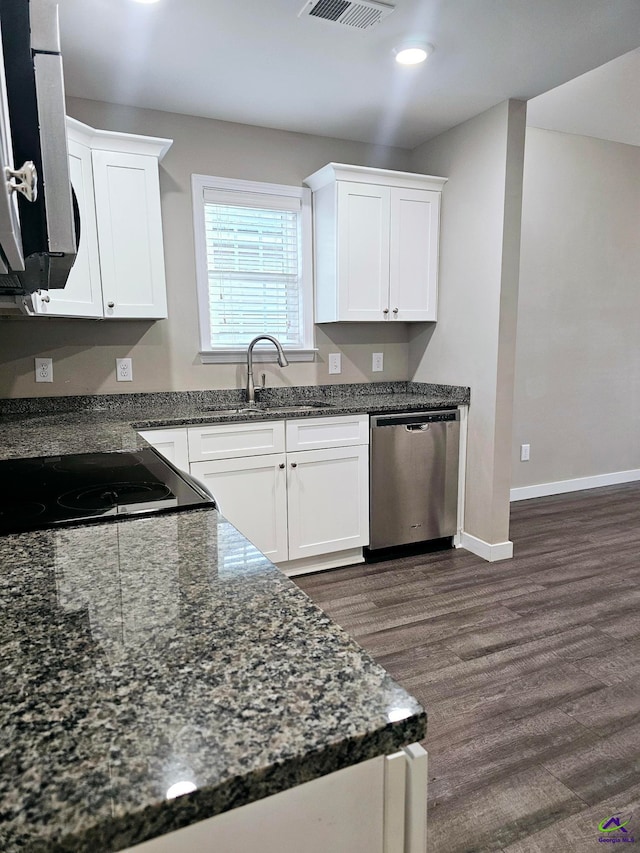 kitchen featuring white cabinetry, stainless steel dishwasher, dark stone counters, and dark hardwood / wood-style flooring