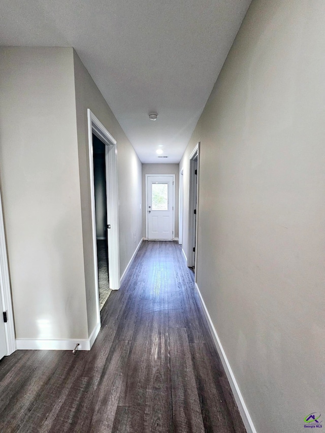 hall with dark hardwood / wood-style floors