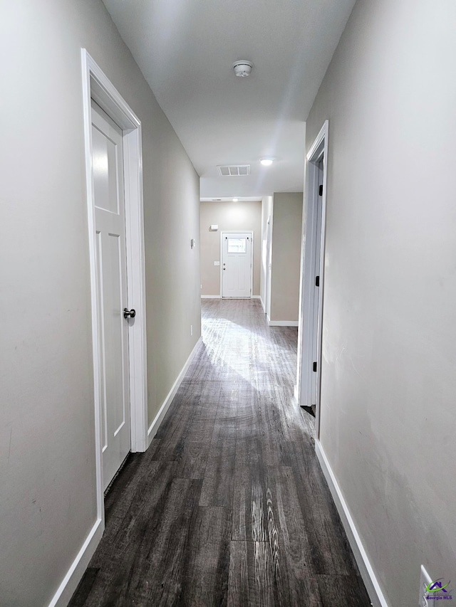corridor featuring dark hardwood / wood-style flooring