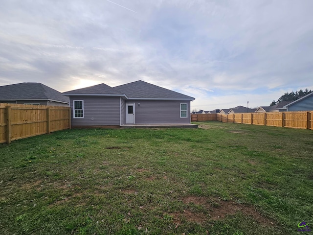 rear view of property with a yard