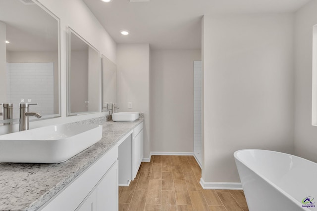 bathroom featuring vanity and a tub