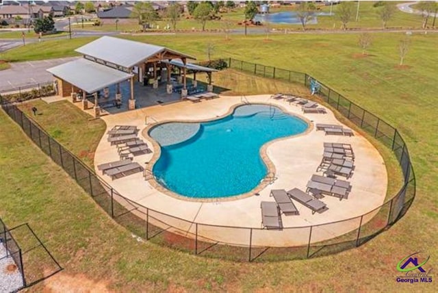 view of swimming pool with a lawn and a patio