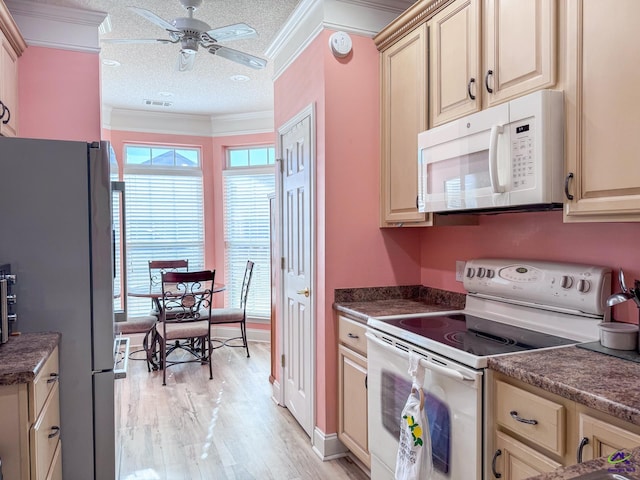 kitchen with crown molding, light wood-type flooring, a textured ceiling, and white appliances