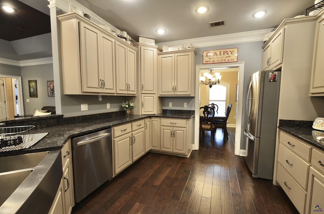 kitchen featuring ornamental molding, stainless steel appliances, and cream cabinetry