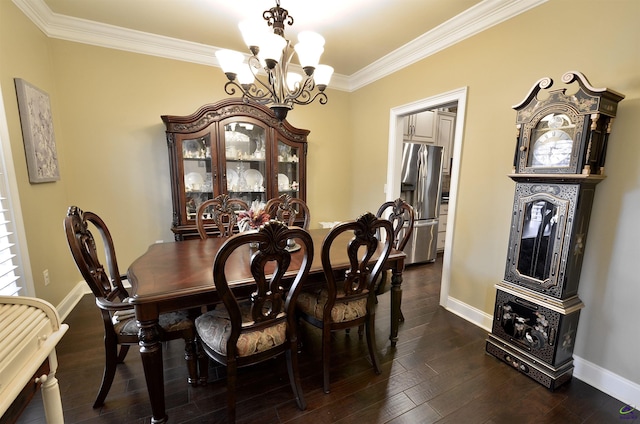 dining room featuring dark hardwood / wood-style flooring, crown molding, and a chandelier