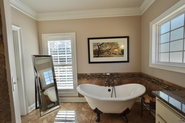 bathroom featuring ornamental molding, vanity, and a bathtub