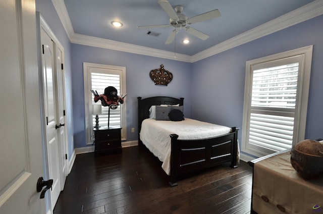 bedroom featuring ceiling fan, ornamental molding, dark hardwood / wood-style flooring, and a closet