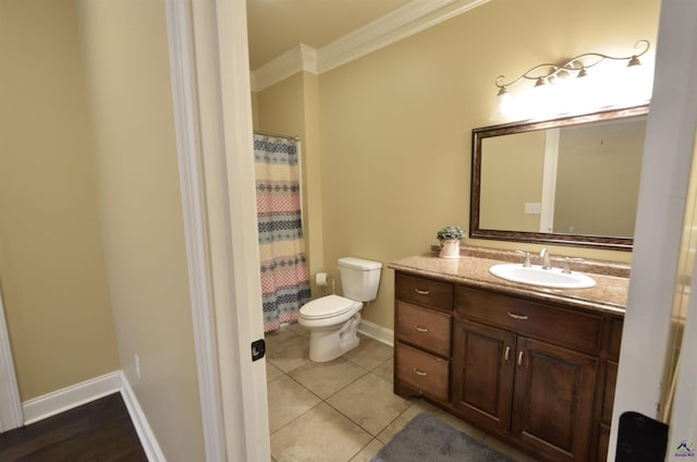 bathroom with vanity, crown molding, tile patterned floors, and toilet