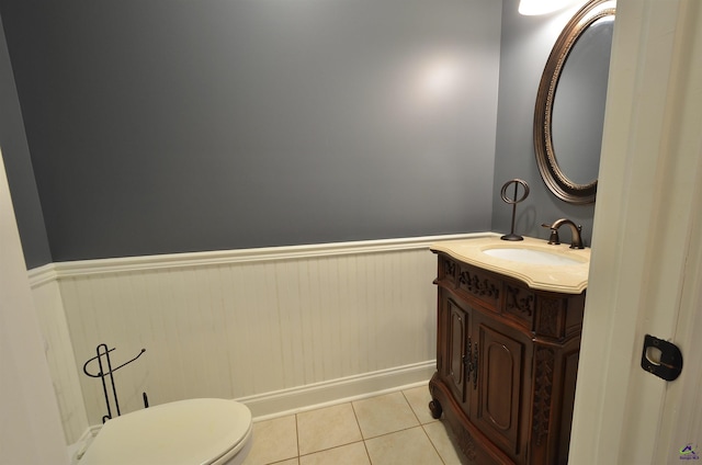 bathroom featuring vanity, toilet, and tile patterned flooring