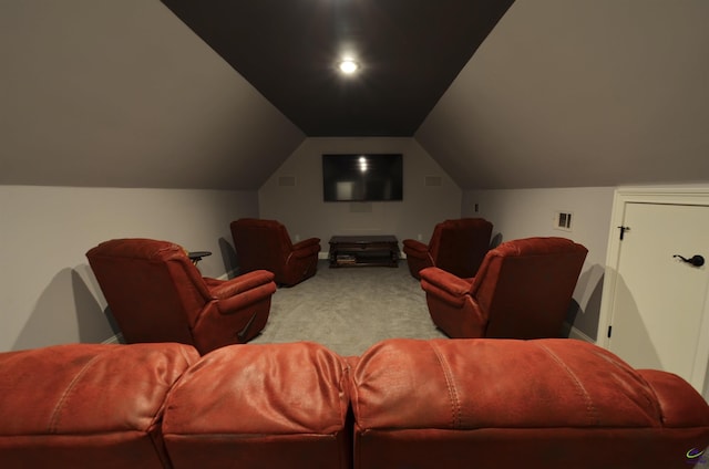 home theater room featuring vaulted ceiling and carpet floors