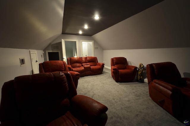 home theater room featuring carpet flooring and vaulted ceiling