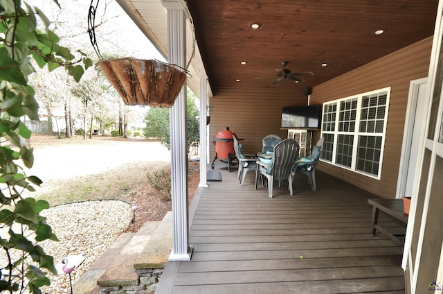 wooden deck featuring ceiling fan