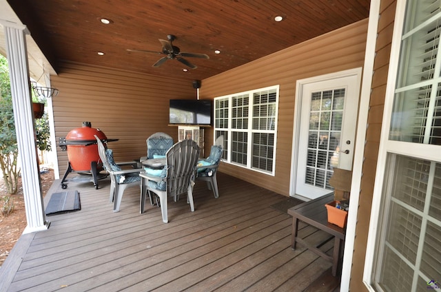 wooden deck with area for grilling and ceiling fan