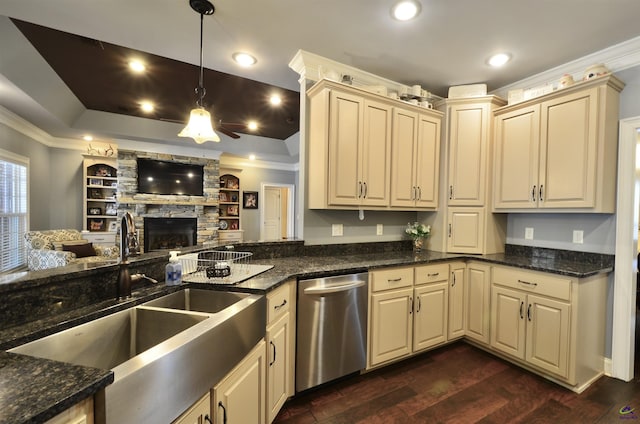 kitchen with dishwasher, sink, dark stone counters, hanging light fixtures, and ornamental molding