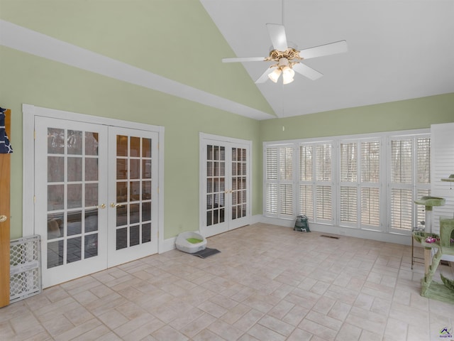 unfurnished sunroom with french doors, ceiling fan, lofted ceiling, and plenty of natural light