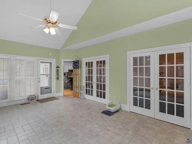 unfurnished sunroom featuring lofted ceiling, french doors, and ceiling fan