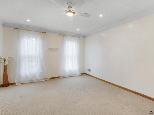 unfurnished room featuring ceiling fan, carpet floors, ornamental molding, and a textured ceiling