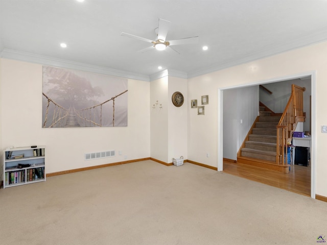 carpeted spare room with crown molding and ceiling fan