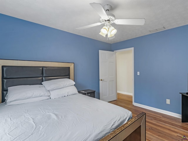 bedroom featuring dark wood-type flooring and ceiling fan